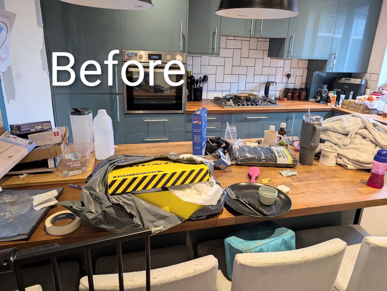 Kitchen breakfast bar covered in clutter before cleaning