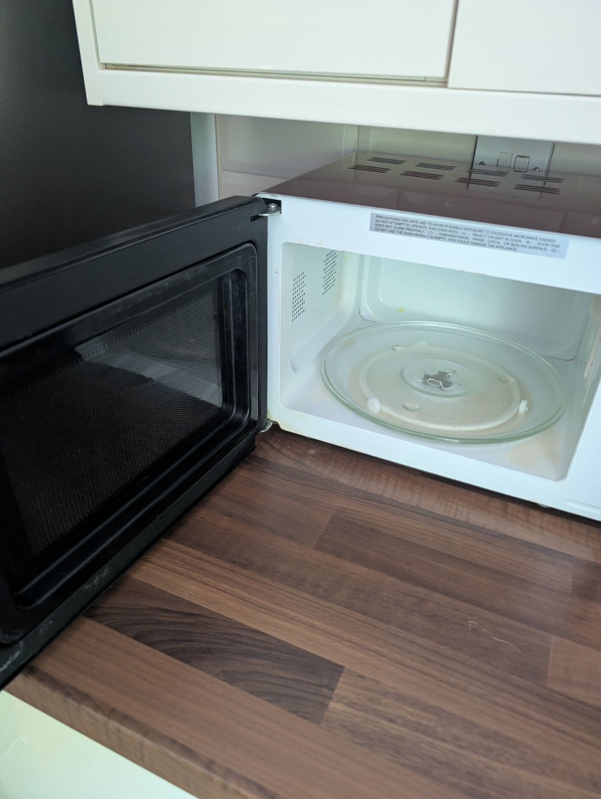 Microwave gleaming inside with clean turntable after cleaning